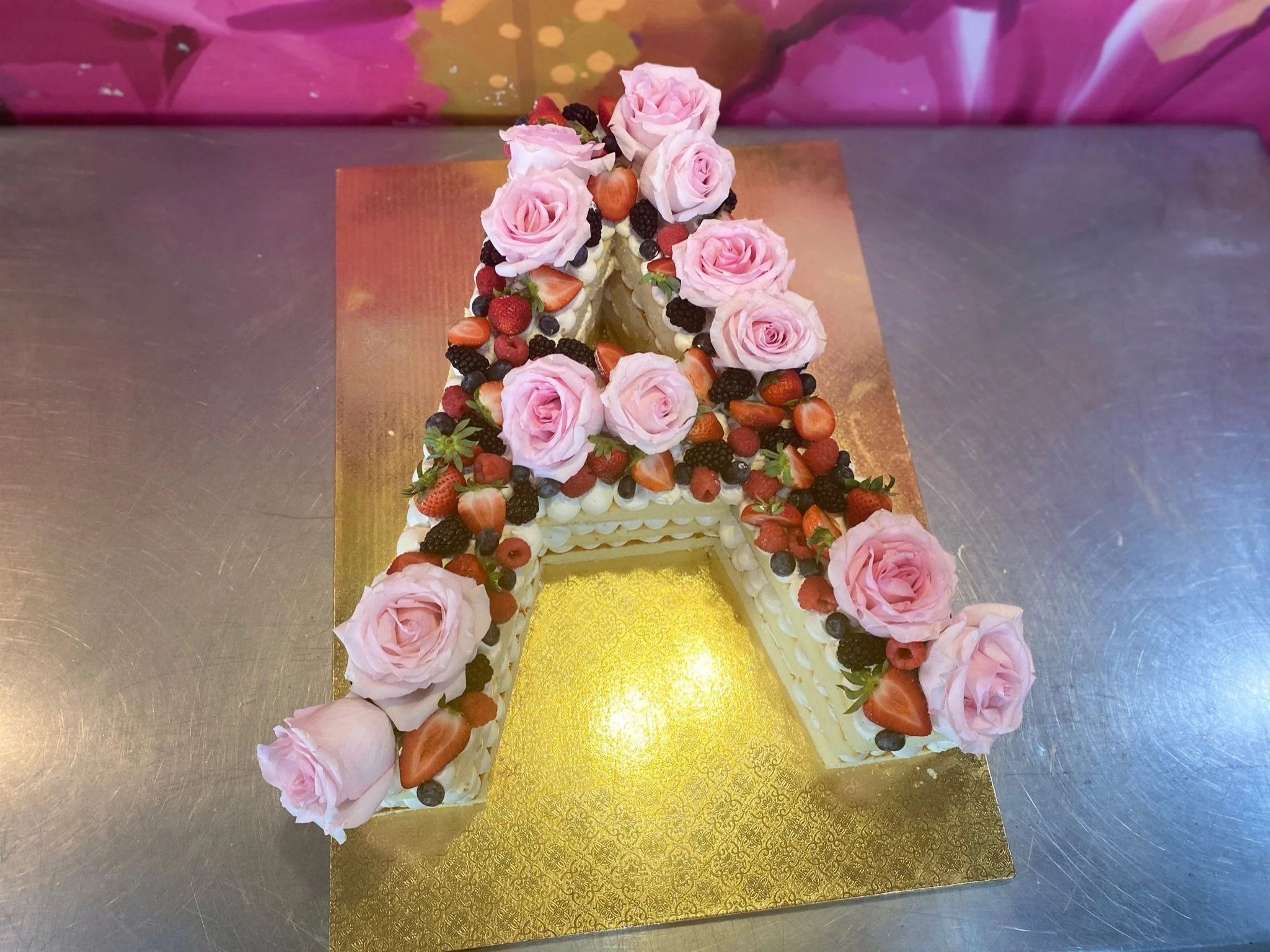 Golden tower shaped cake pink roses