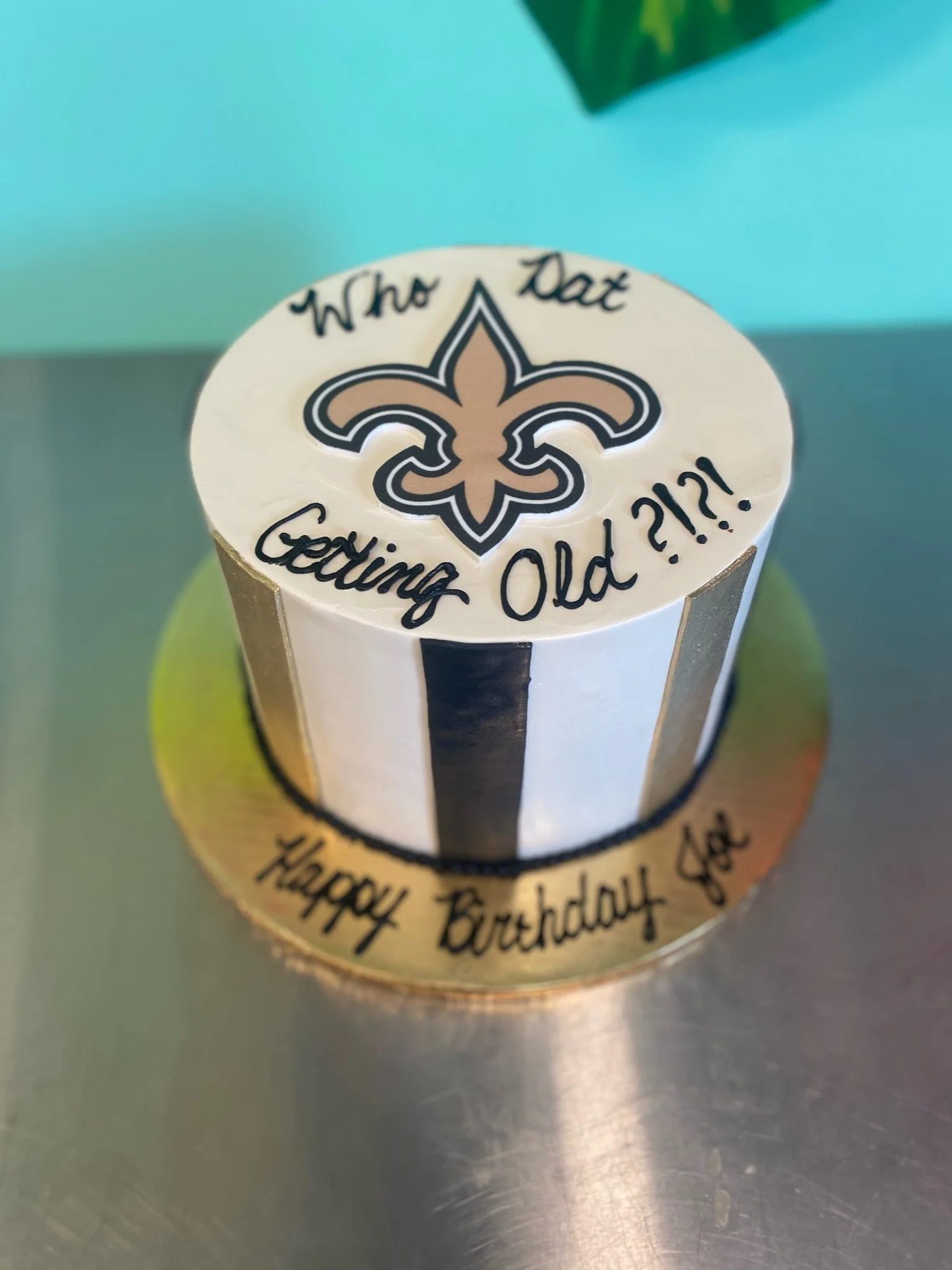White black new orleans saints fleur de lis cake