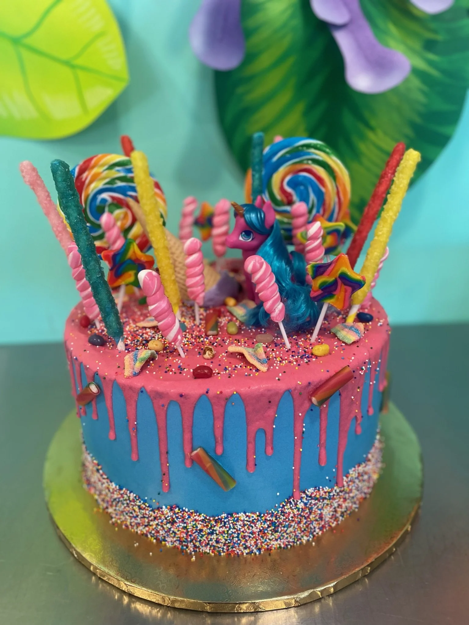 Blue pink rainbow candy lollipops drip cake