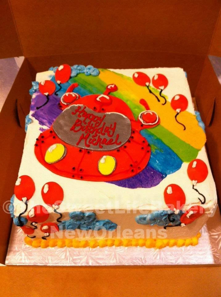 Red blue yellow superhero birthday cake