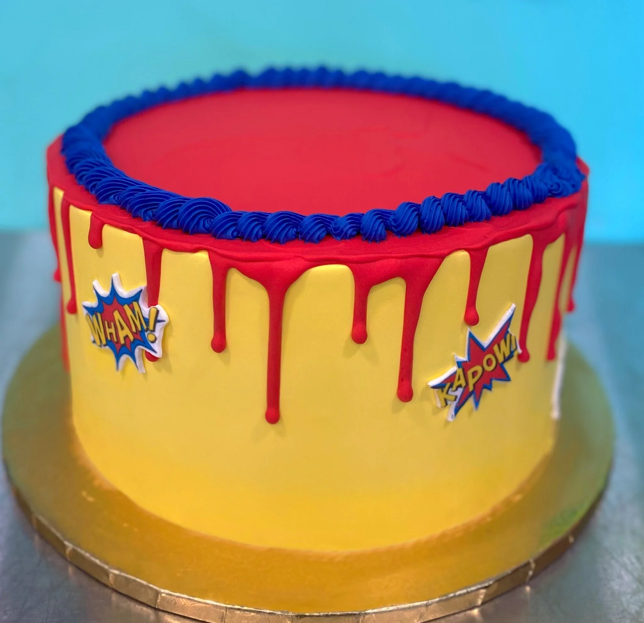 Red yellow blue chocolate drip comic book birthday cake