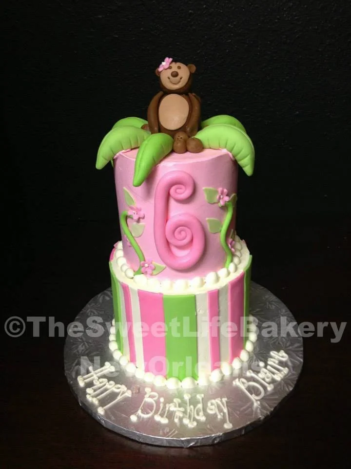 Pink green monkey jungle first birthday cake