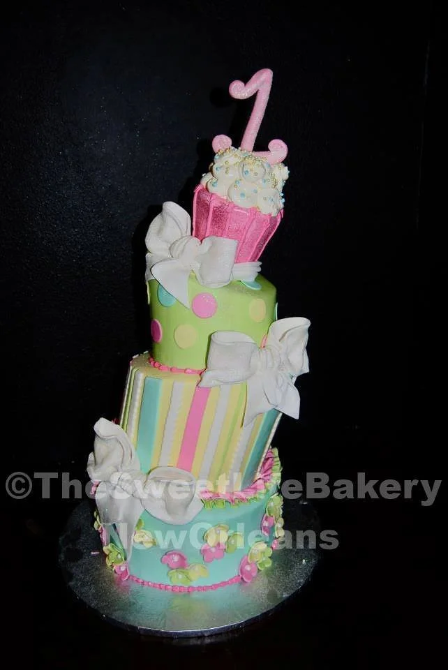 Pastel pink tall tiered first birthday cake