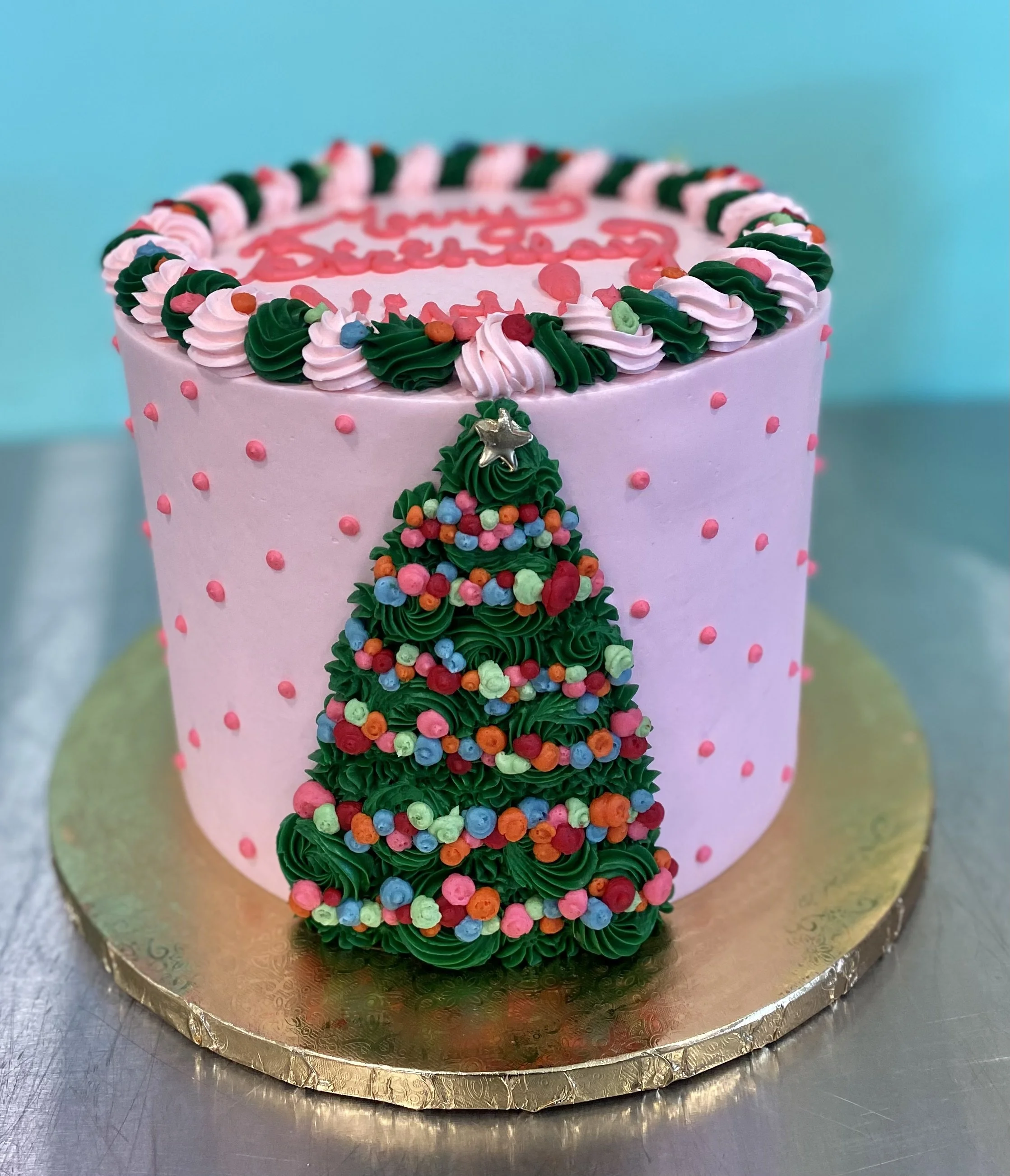 Pink christmas tree decorated holiday cake