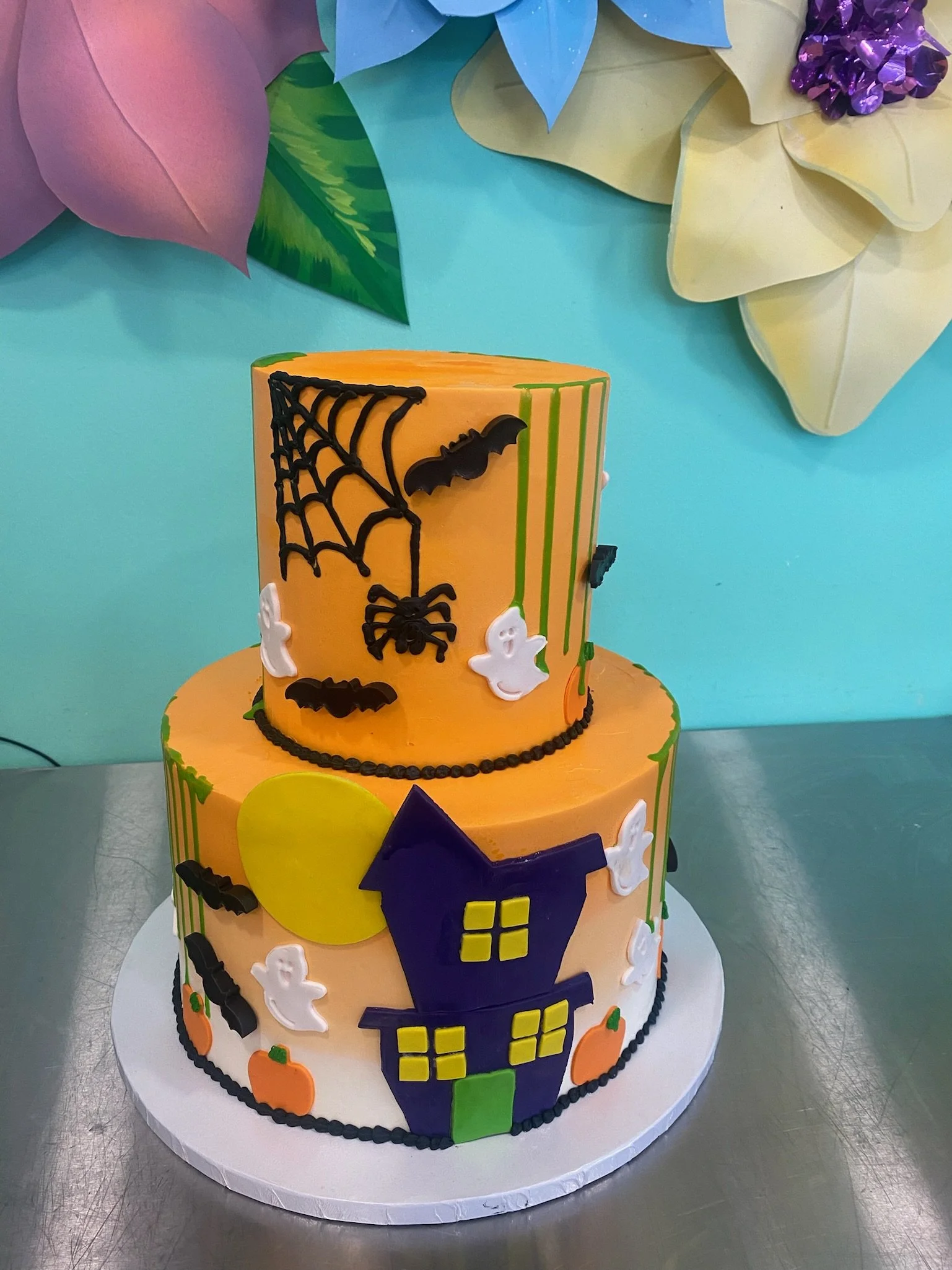 Orange purple halloween themed tiered pumpkin haunted cake