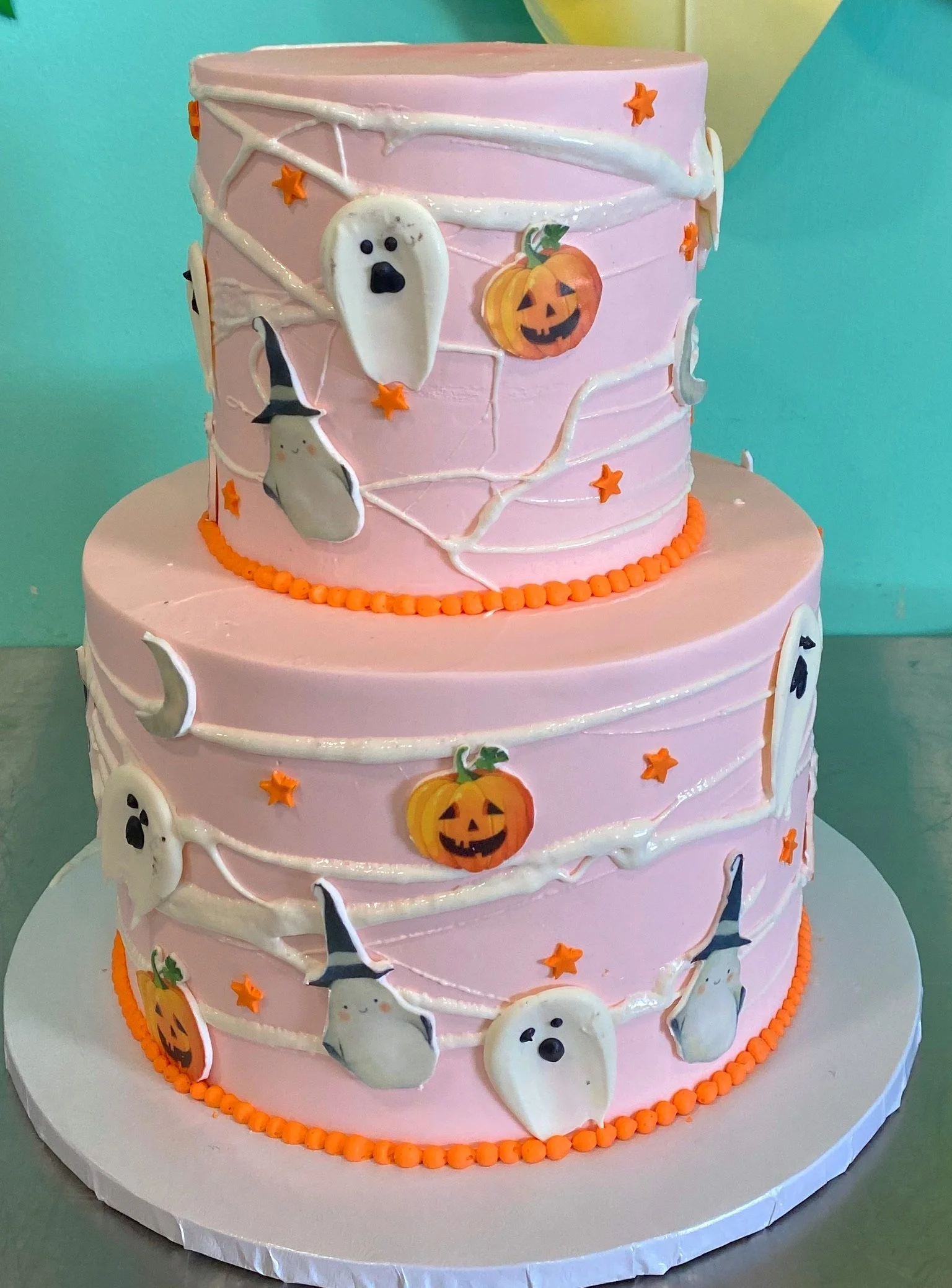Pink halloween ghost pattern two tier cake