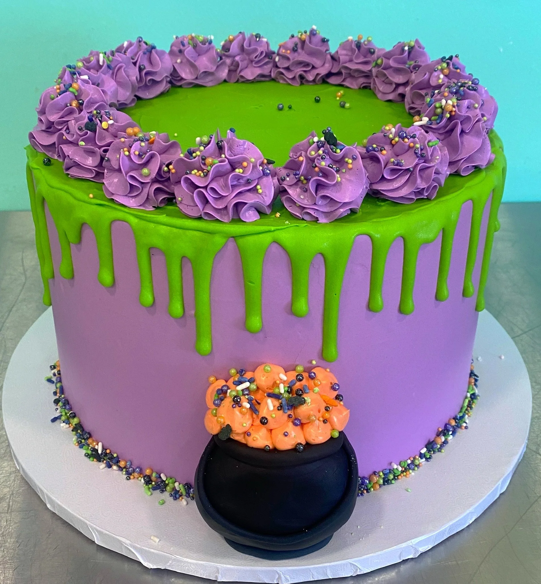 Purple green halloween witch cauldron slime cake