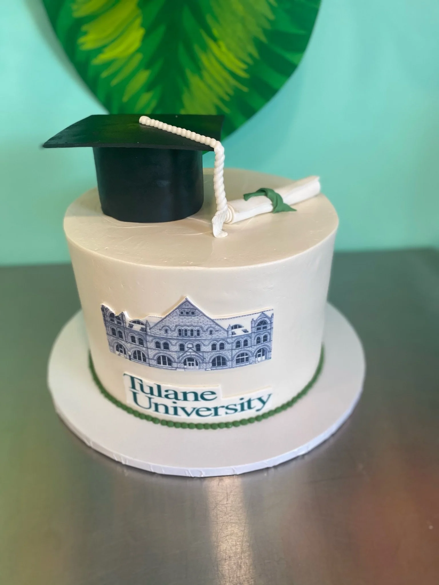 White graduation cap diploma cake blue