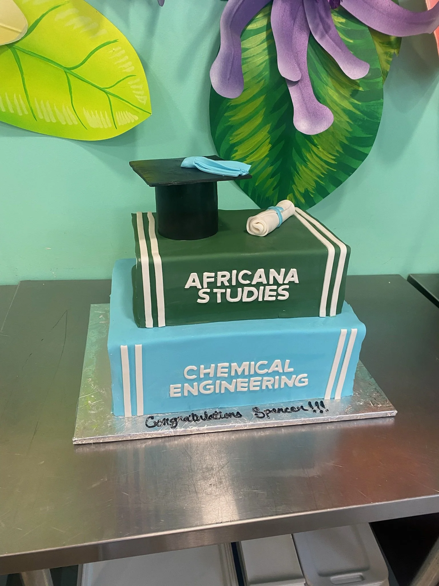 Green graduation books university cake