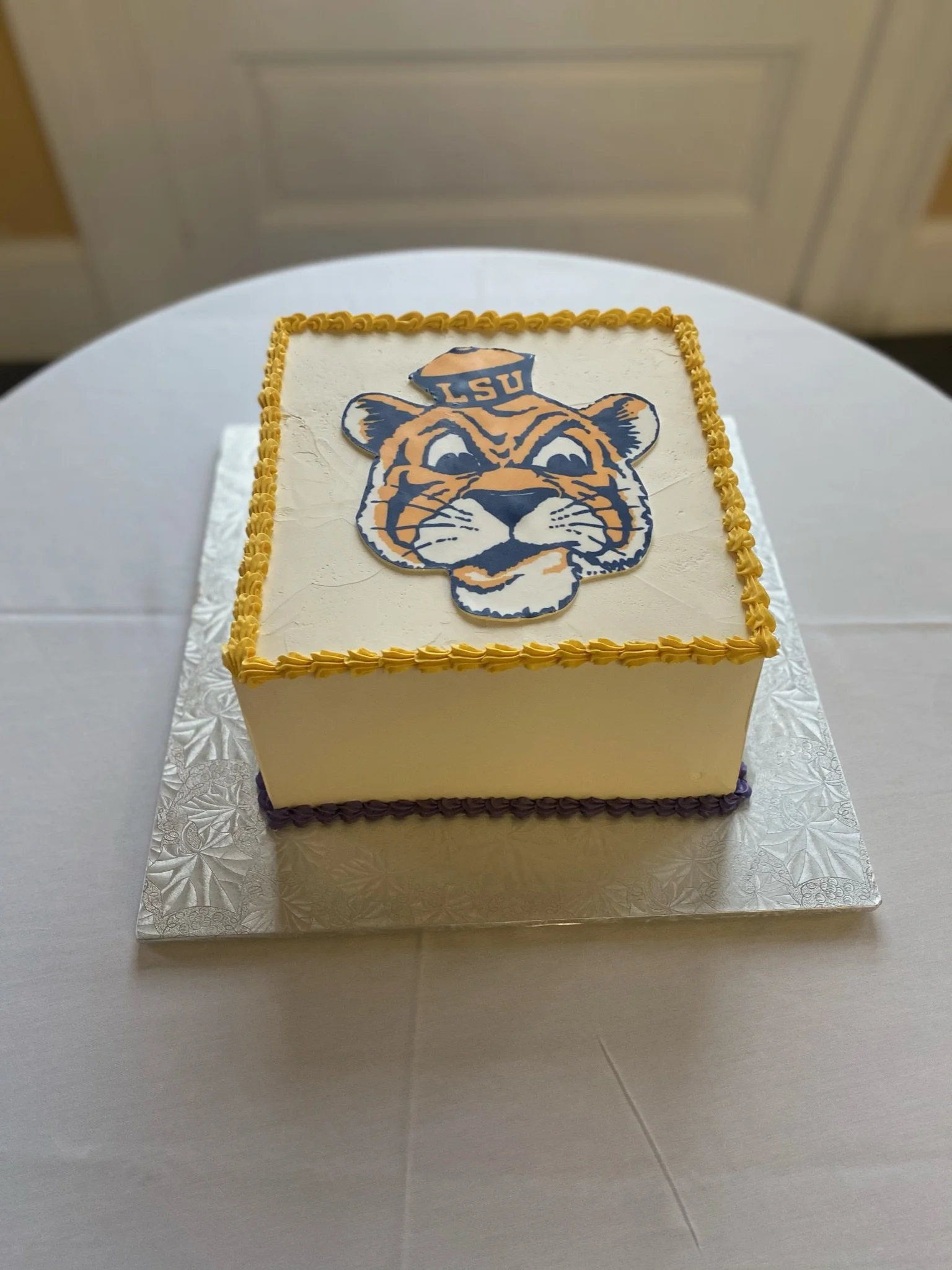 White yellow school logo diploma graduation cake