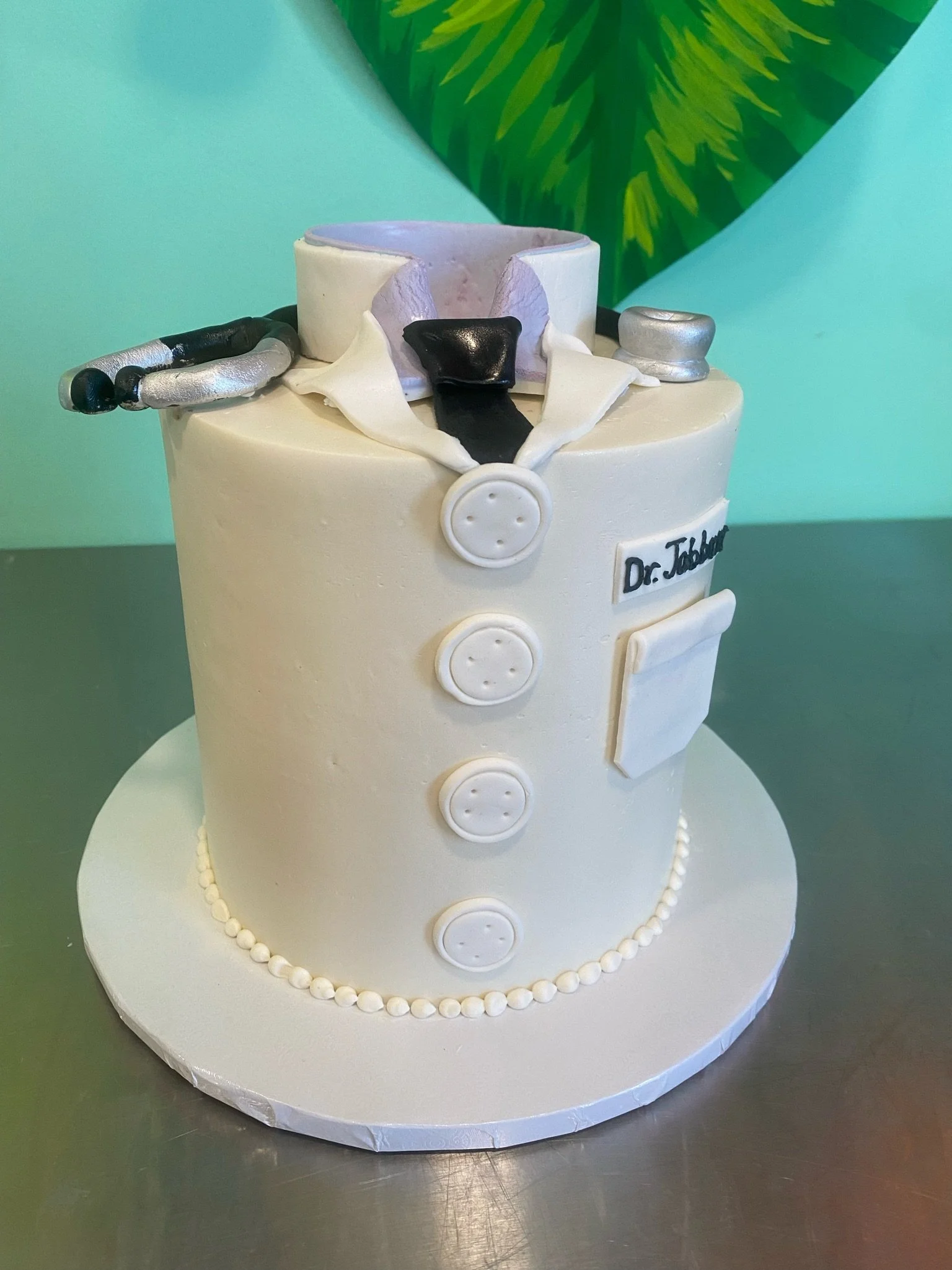 White doctor's lab coat stethoscope graduation cake