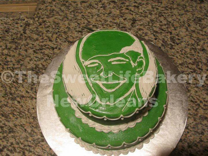 Green round graduation cake football school logo