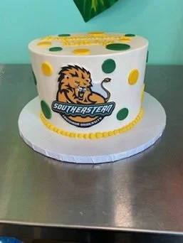 White school graduation mascot cake orange
