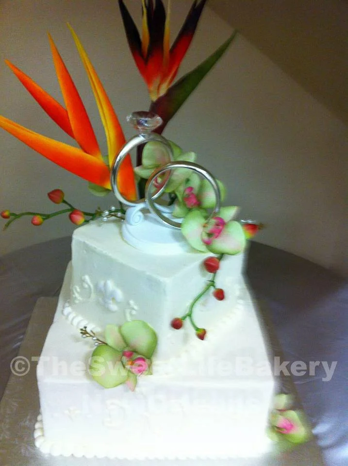 White tropical flowers cake exotic birds