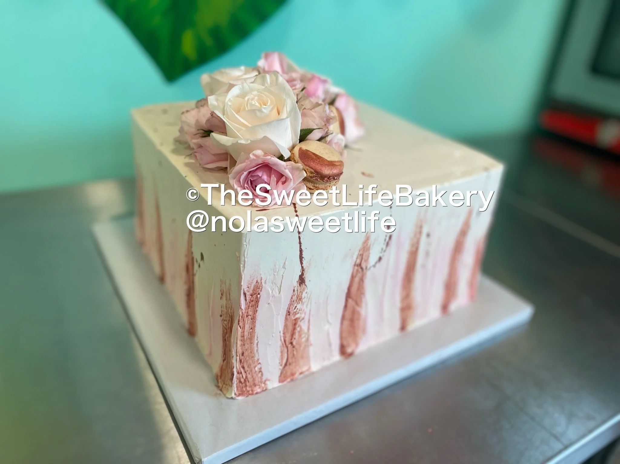 White pink baby shower drip cake flowers
