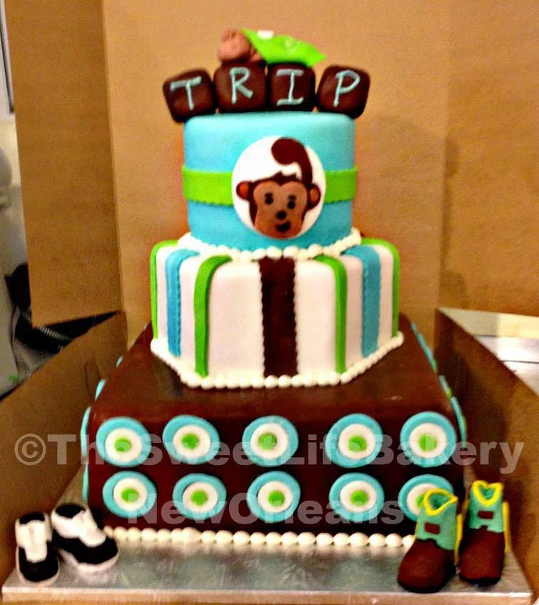 Colorful tiered baby shower circus animal cake