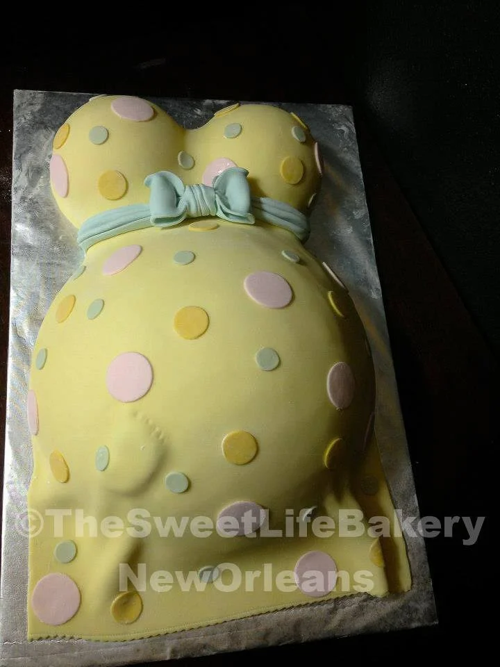 Yellow white baby shower pregnant belly cake