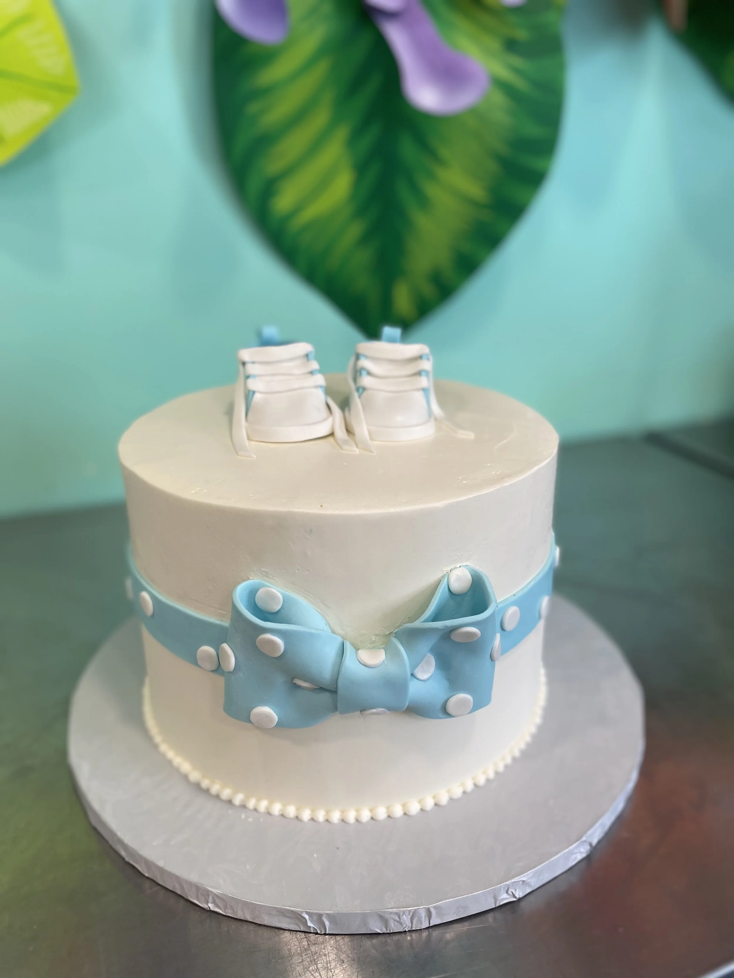 White baby shower cake blue fondant bow