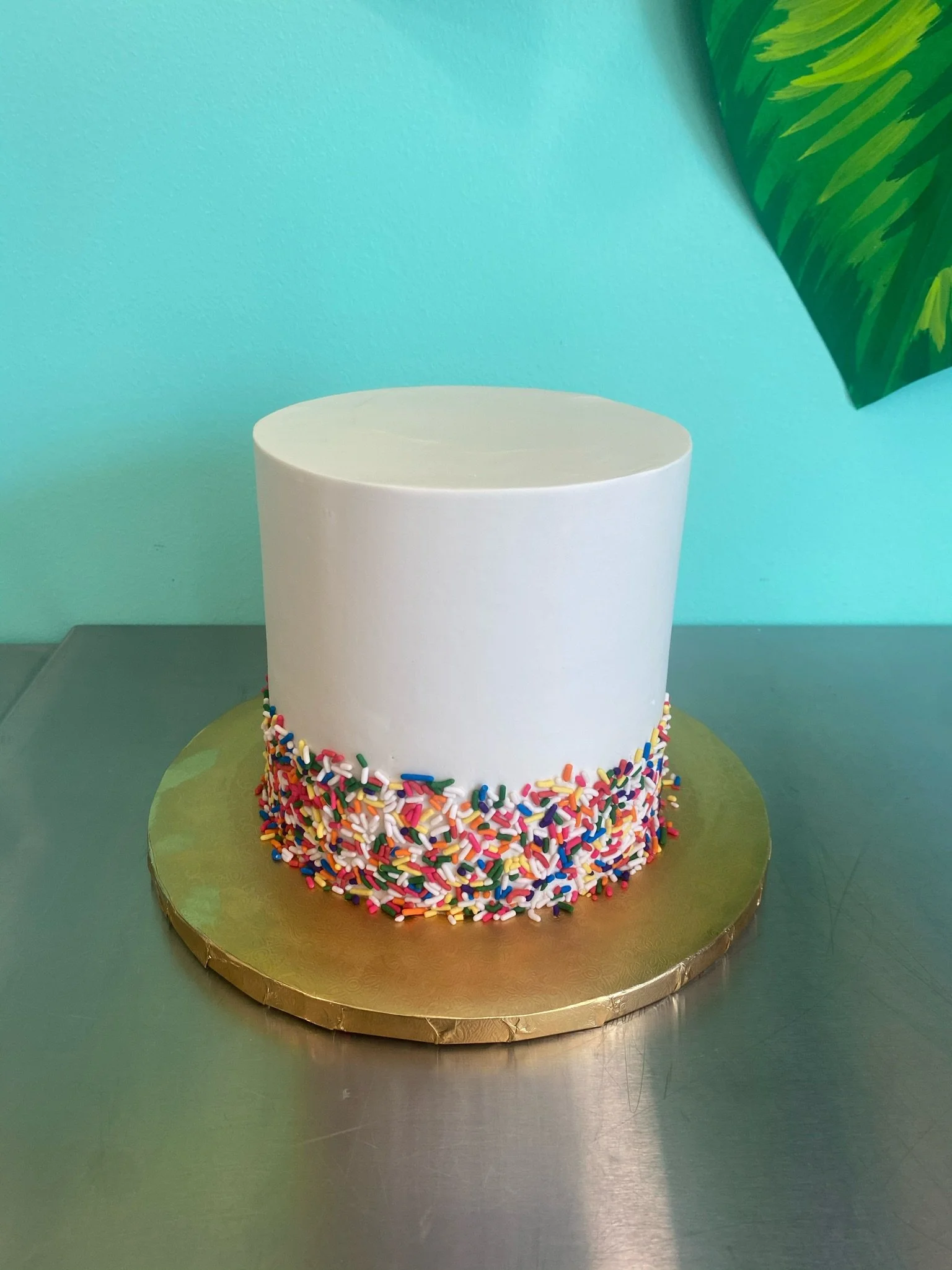 White rainbow sprinkles baby shower cake